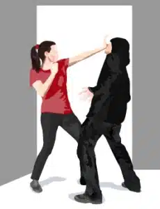 Woman defending herself against a hooded man in dark clothing